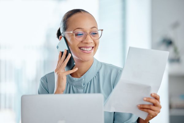 Happy business woman talking on a phone call, discussing contract with a client or colleague. Femal.